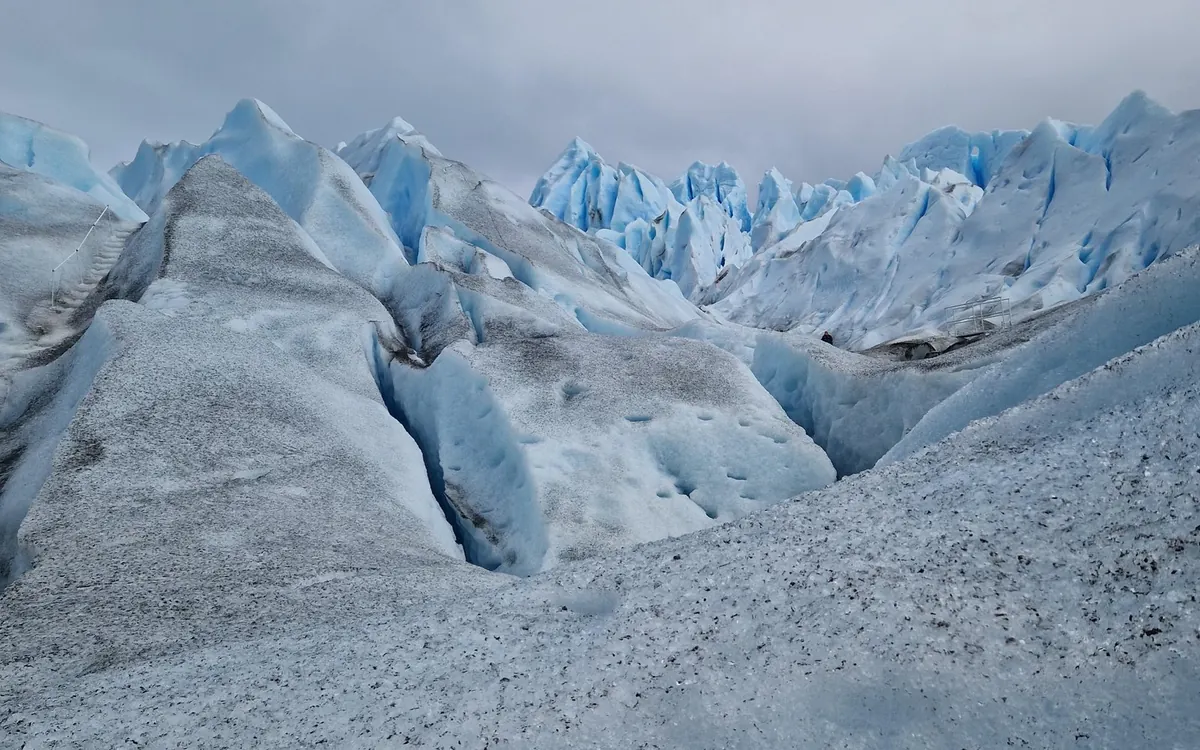 A guided group walking the Perito Moreno Glacier in crampons on an ice trekking tour